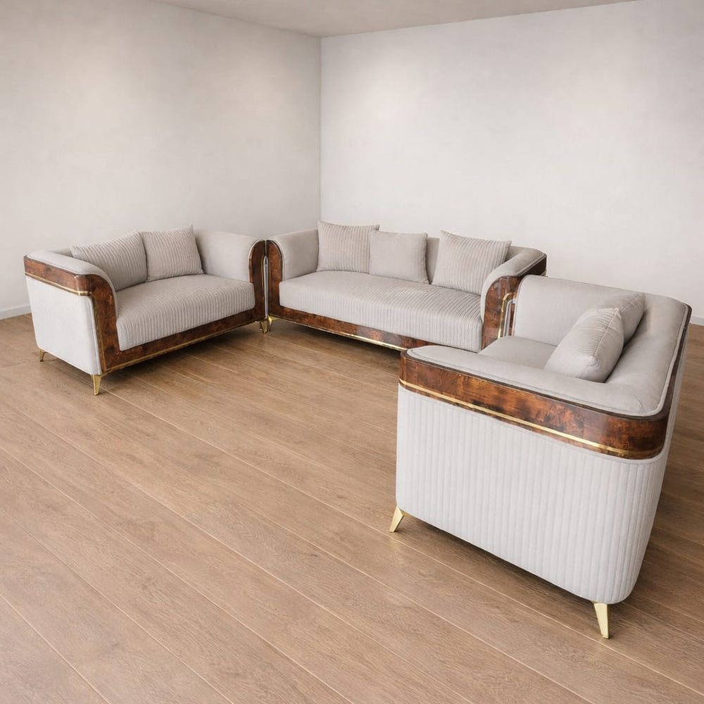 Modern sofa set with wooden frame and gold legs in a minimalistic room.